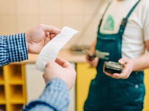 Hands holding receipt.